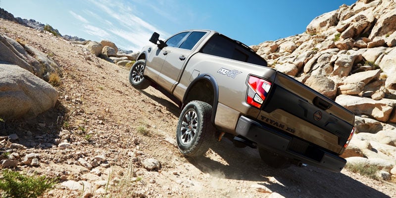2024 Nissan Titan XD driving in the mountains